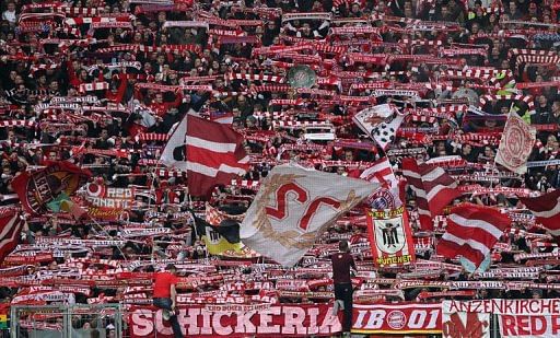 Bayern fans wave flags during the team's Bundesliga match against Eintracht Frankfurt in Frankfurt,on April 6, 2013